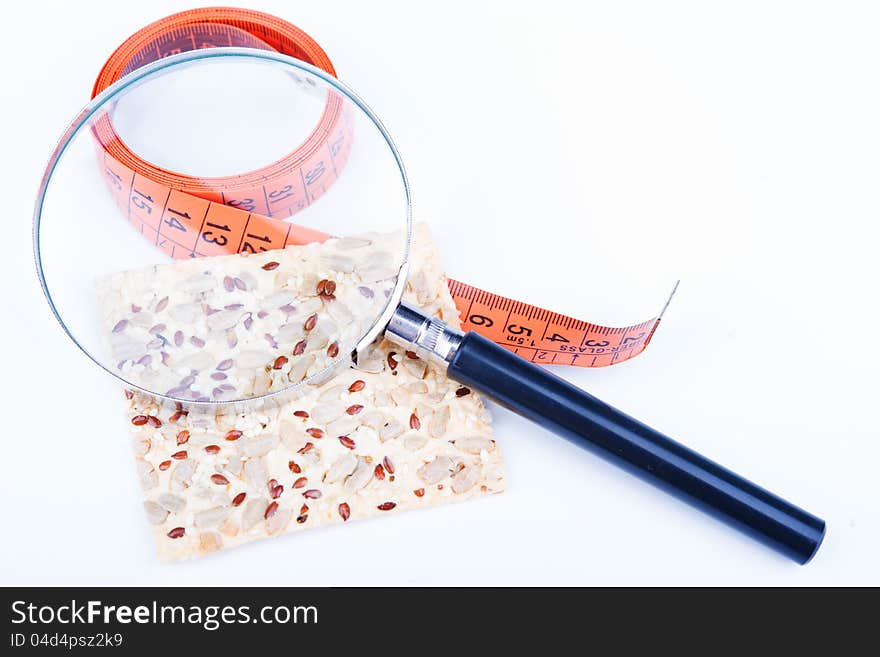 Cracker with a measuring tape isolated on white. Cracker with a measuring tape isolated on white