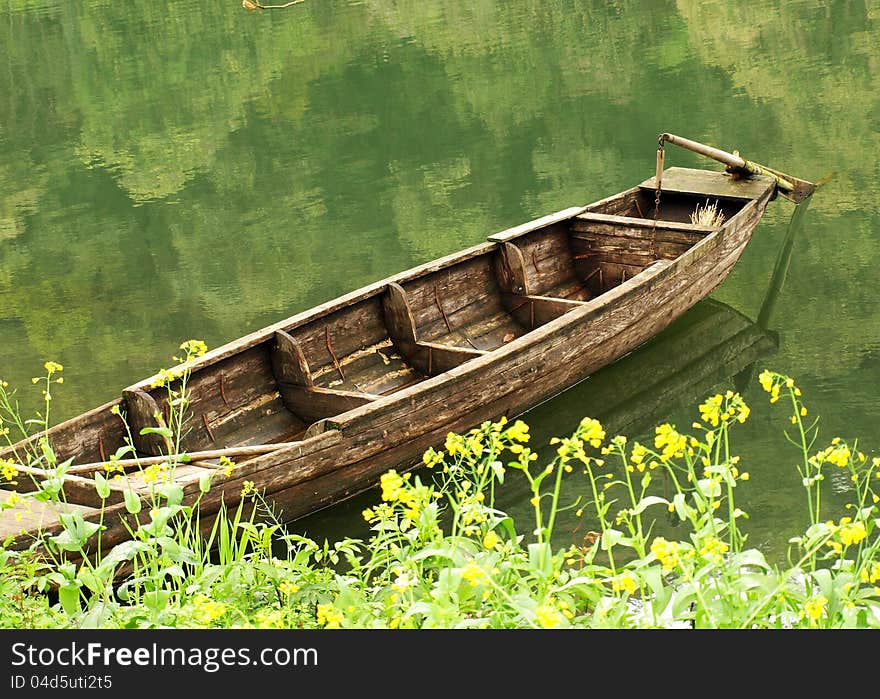 Ancient small boat, anchors in jiangxi China rural the shore. Ancient small boat, anchors in jiangxi China rural the shore.