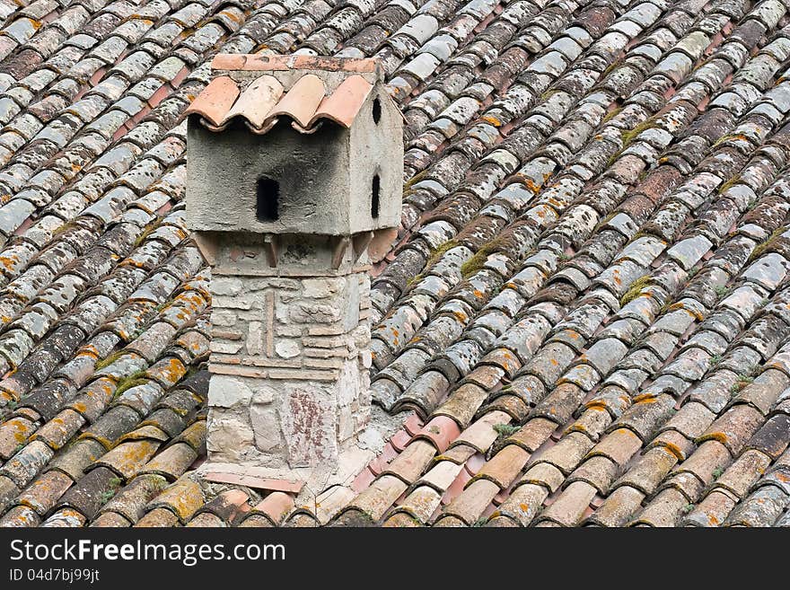 Large chimney of stone, brick and masonry and roof of bent tiles. Large chimney of stone, brick and masonry and roof of bent tiles