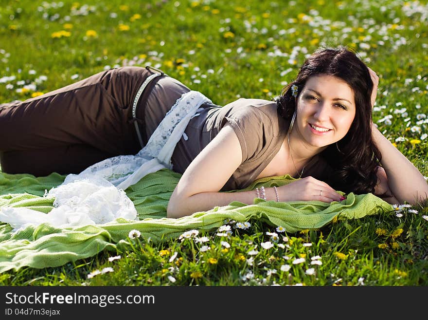 Beautiful Girl Lying On The Grass With Flowers