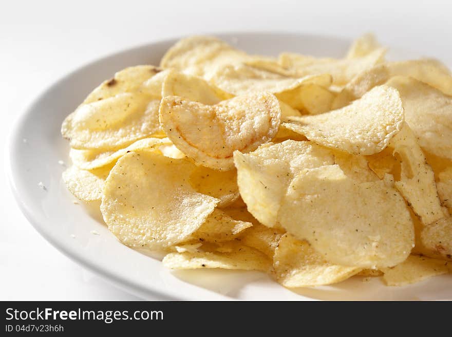 Some potato chips on the white plate