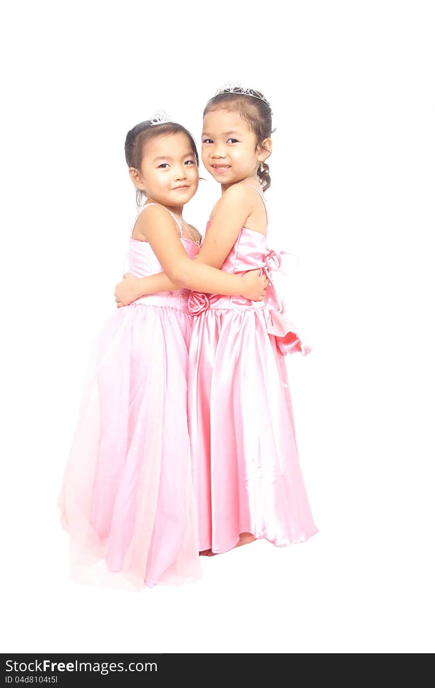 Two asian little girls in pink dress posing by hugging each other. Two asian little girls in pink dress posing by hugging each other.