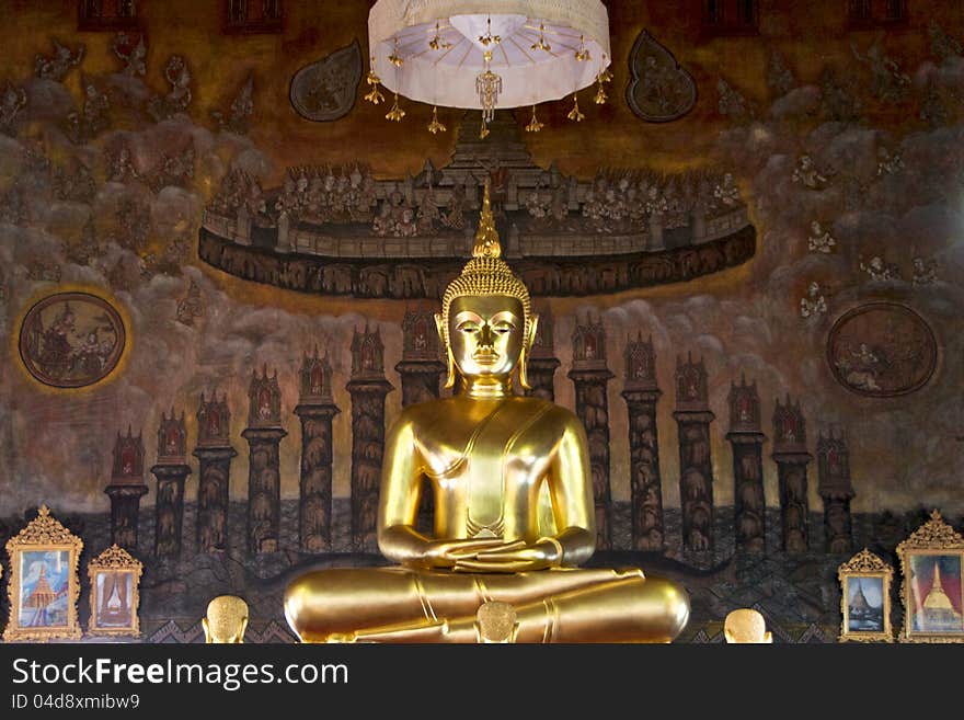 Golden buddha statue on ancient mural painting background in thai temple. Golden buddha statue on ancient mural painting background in thai temple