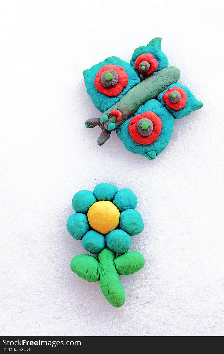 A hand-made flower and a butterfly from dough. A hand-made flower and a butterfly from dough