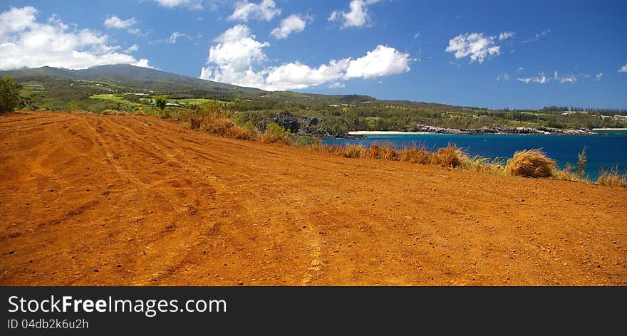 A natural dirt road along the coastline of Maui found to be traveled and enjoyed by tourists. A natural dirt road along the coastline of Maui found to be traveled and enjoyed by tourists