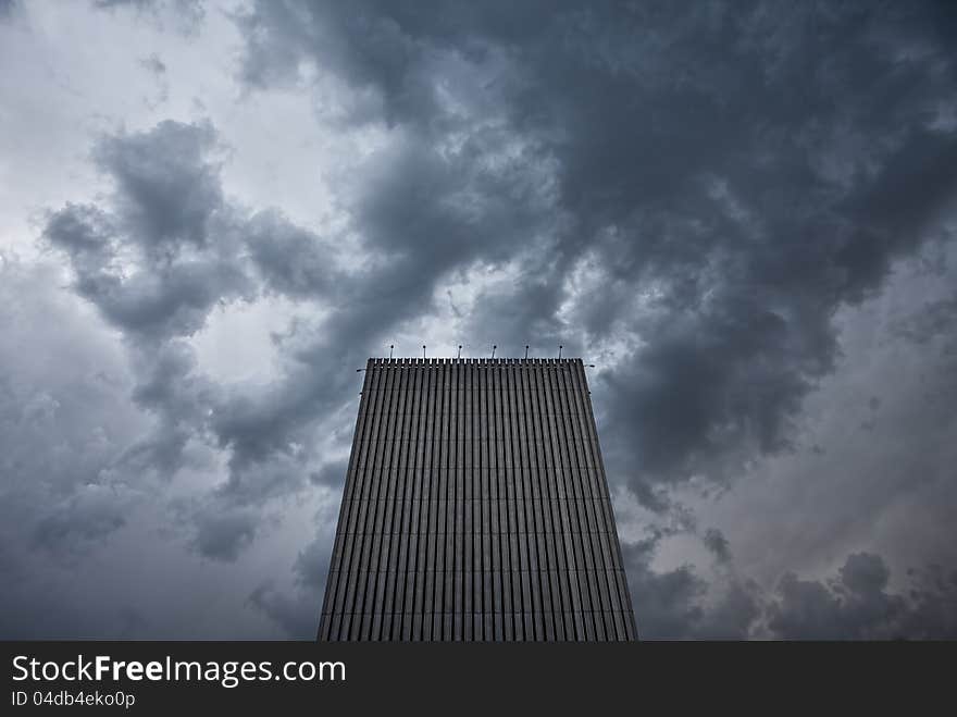 Skyscraper in Kiev, Ukraine, towering high under a stormy clouds. Horizontal with copy space. Skyscraper in Kiev, Ukraine, towering high under a stormy clouds. Horizontal with copy space.