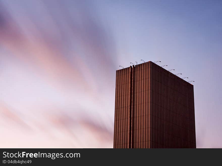 Skyscraper in Kiev, Ukraine, towering high under motion blured clouds. Horizontal with copy space. Skyscraper in Kiev, Ukraine, towering high under motion blured clouds. Horizontal with copy space.