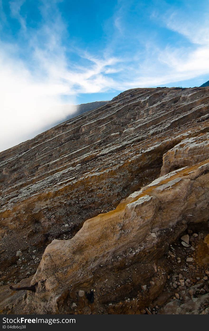 Volcano Ijen crater and clouds, East Java, Indonesia