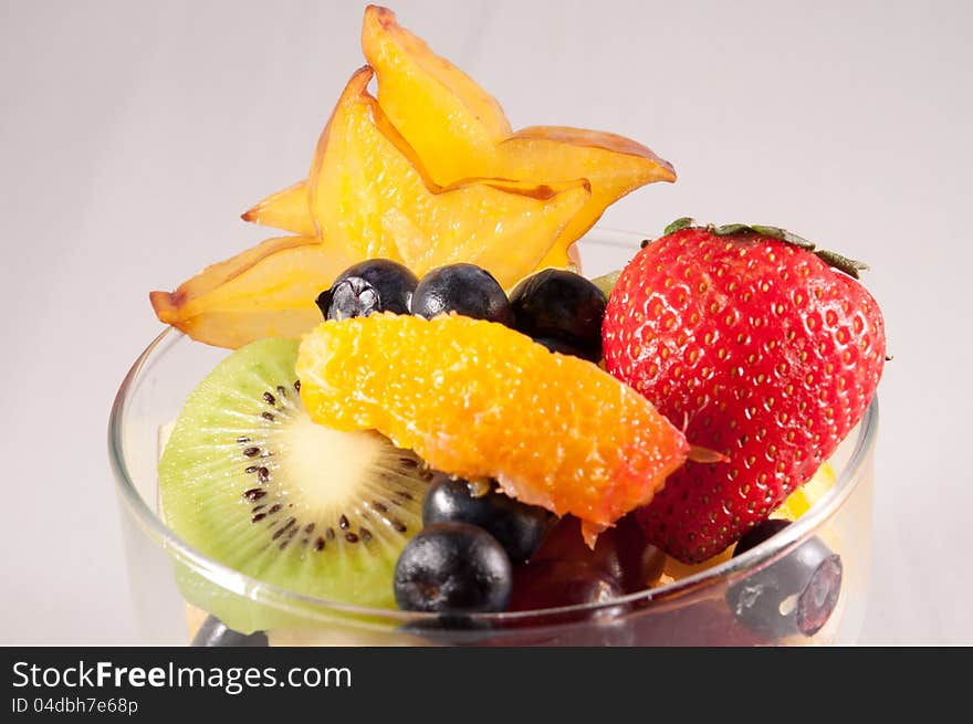 Fruit bowl with starfruit strawberry grapes blueberry orange kiwi. Fruit bowl with starfruit strawberry grapes blueberry orange kiwi