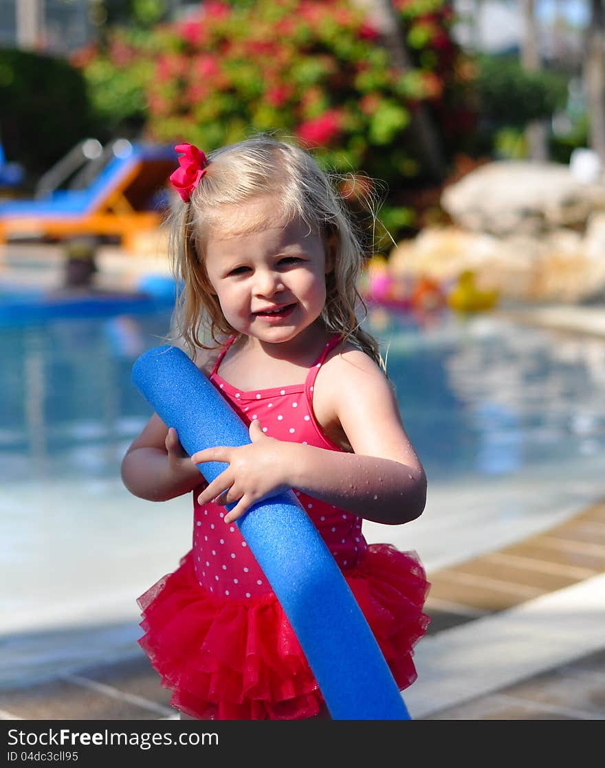 Little Girl on vacation at a resort pool