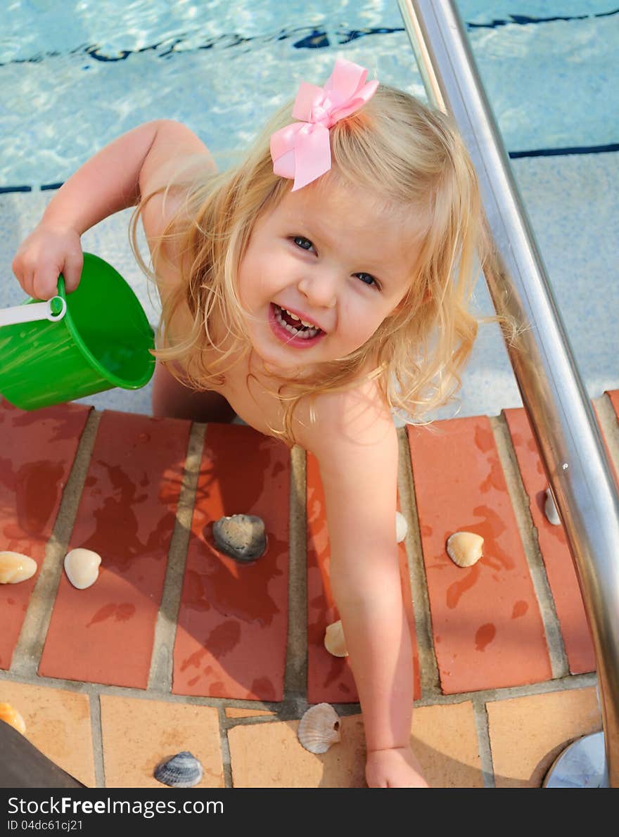 Little girl playing in a swimming pool