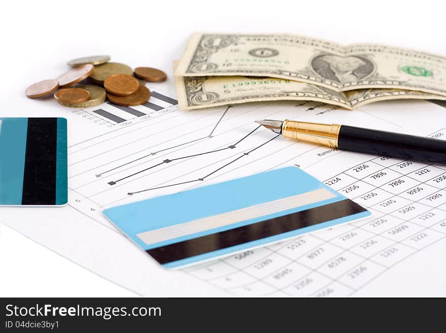 Planning for business. Credit cards, money, and graphics with pen  on white background. Planning for business. Credit cards, money, and graphics with pen  on white background