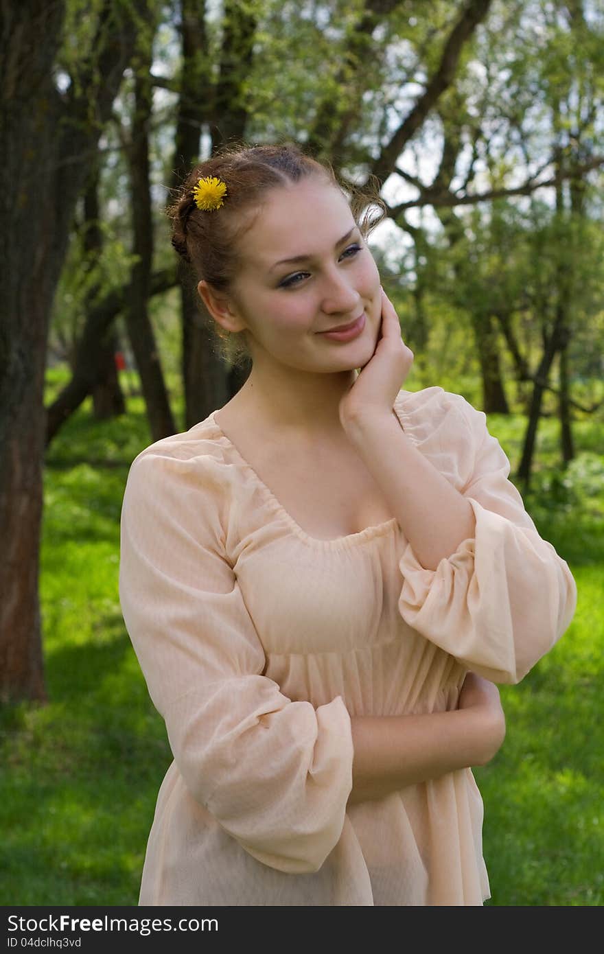 Portrait of a girl on the background of nature in spring