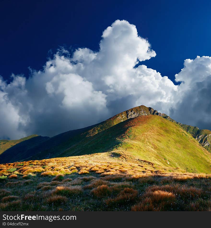 Morning in the mountains, the first beams of a rising sun shine mountains. Ukraine, Carpathians. Morning in the mountains, the first beams of a rising sun shine mountains. Ukraine, Carpathians