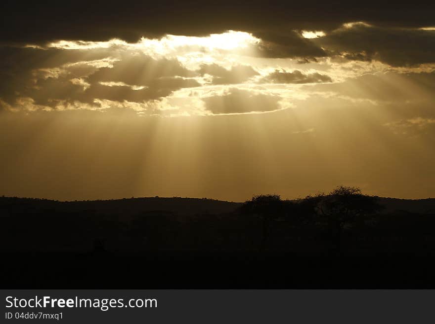 Shafts of light shine down through the clouds on a cloudy day. Shafts of light shine down through the clouds on a cloudy day.