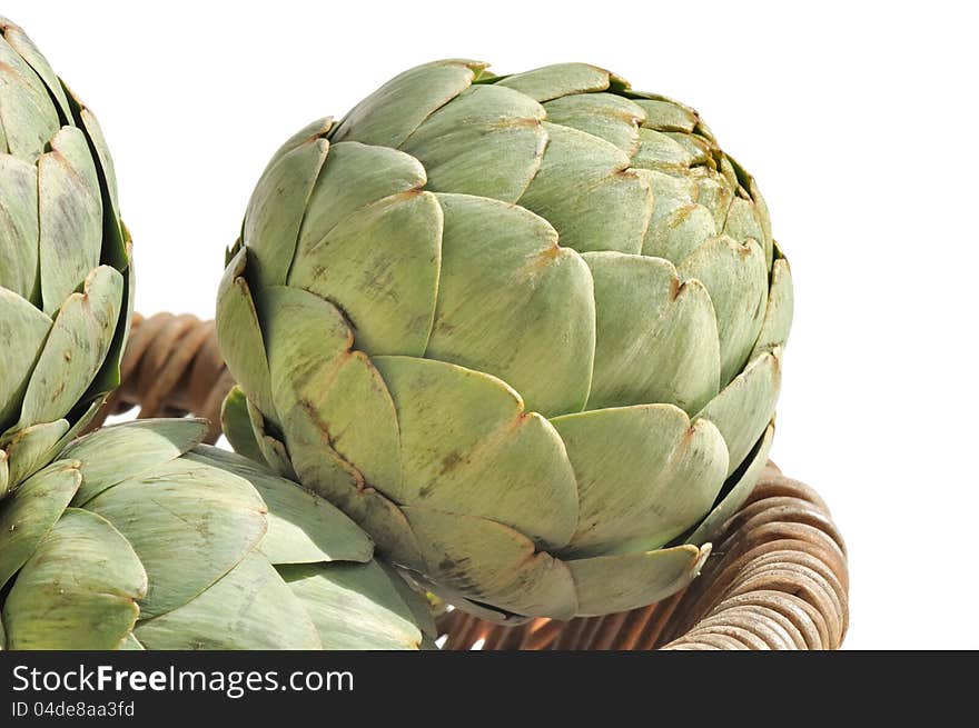 Artichokes in a basket on white background