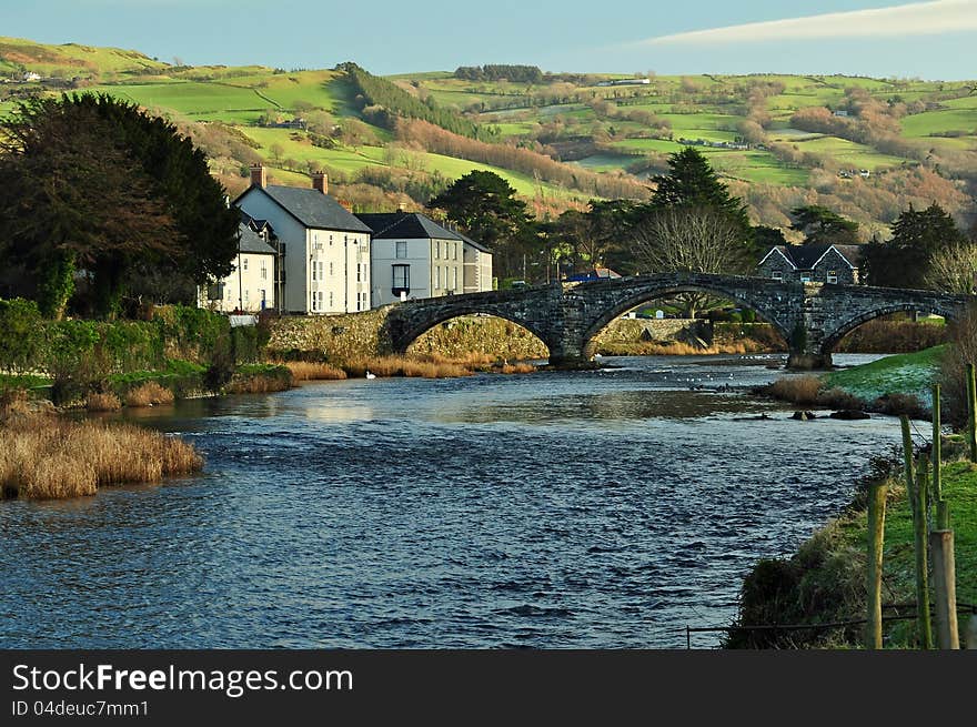 The River Conwy at Llanrwst, North Wales, in bright sunshine, with the hills in the background. The River Conwy at Llanrwst, North Wales, in bright sunshine, with the hills in the background