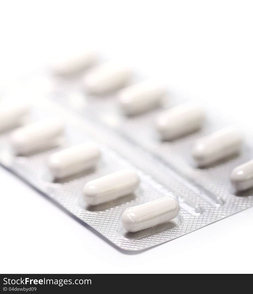 Close up of pills over white background