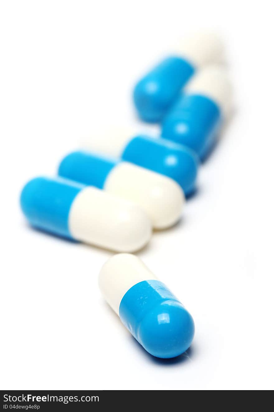 Close up of pills over white background