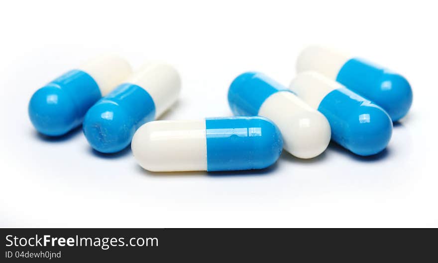 Close up of pills over white background