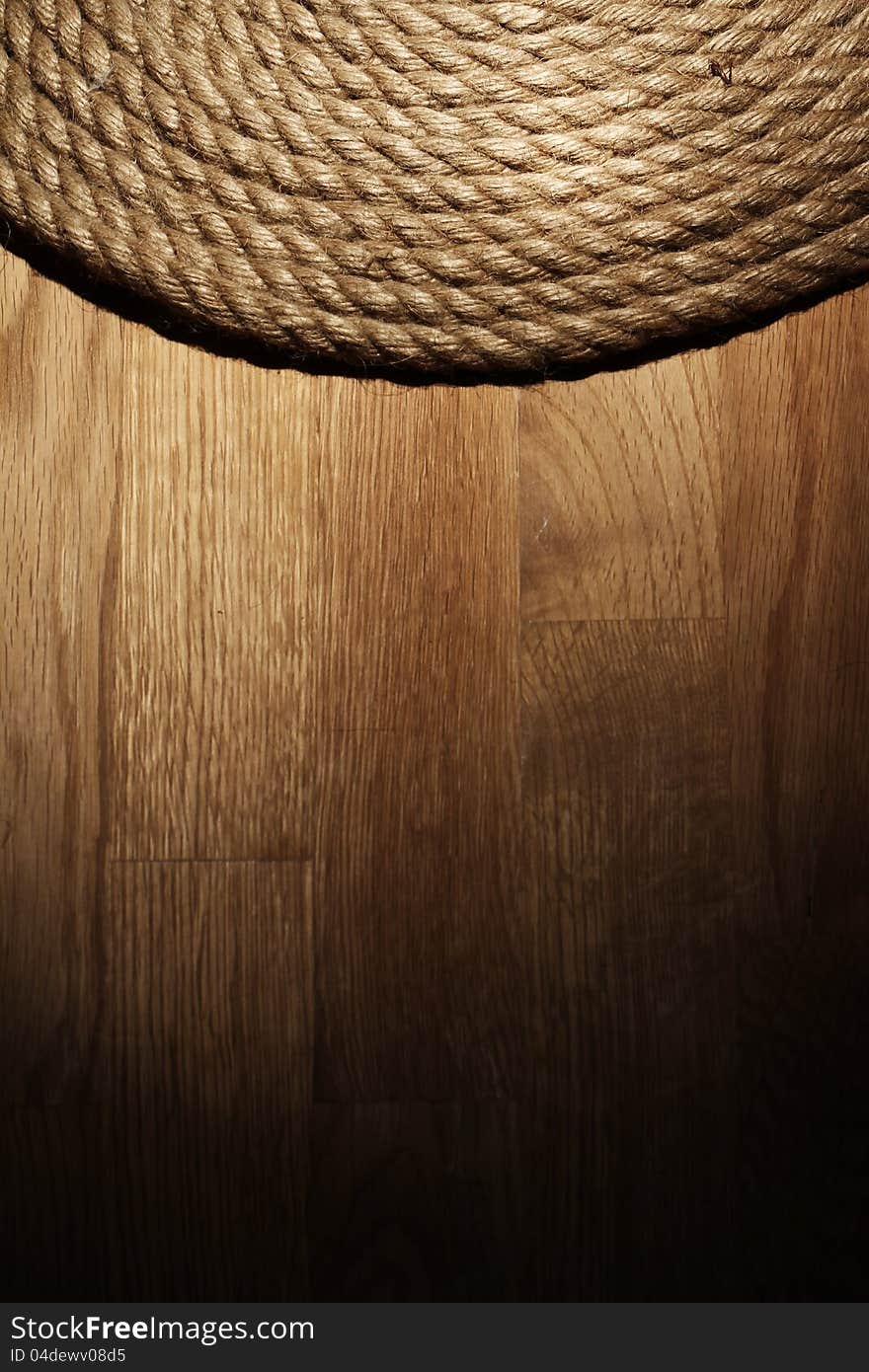 Old rope over wooden background. Old rope over wooden background