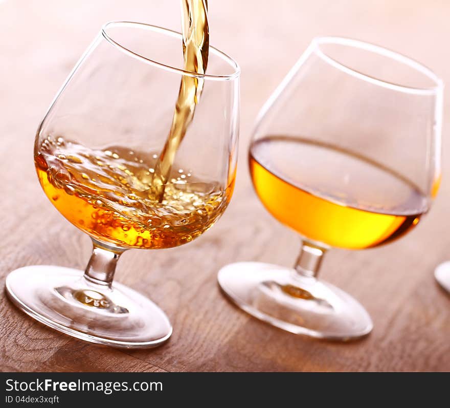 Pouring cognac into the glass