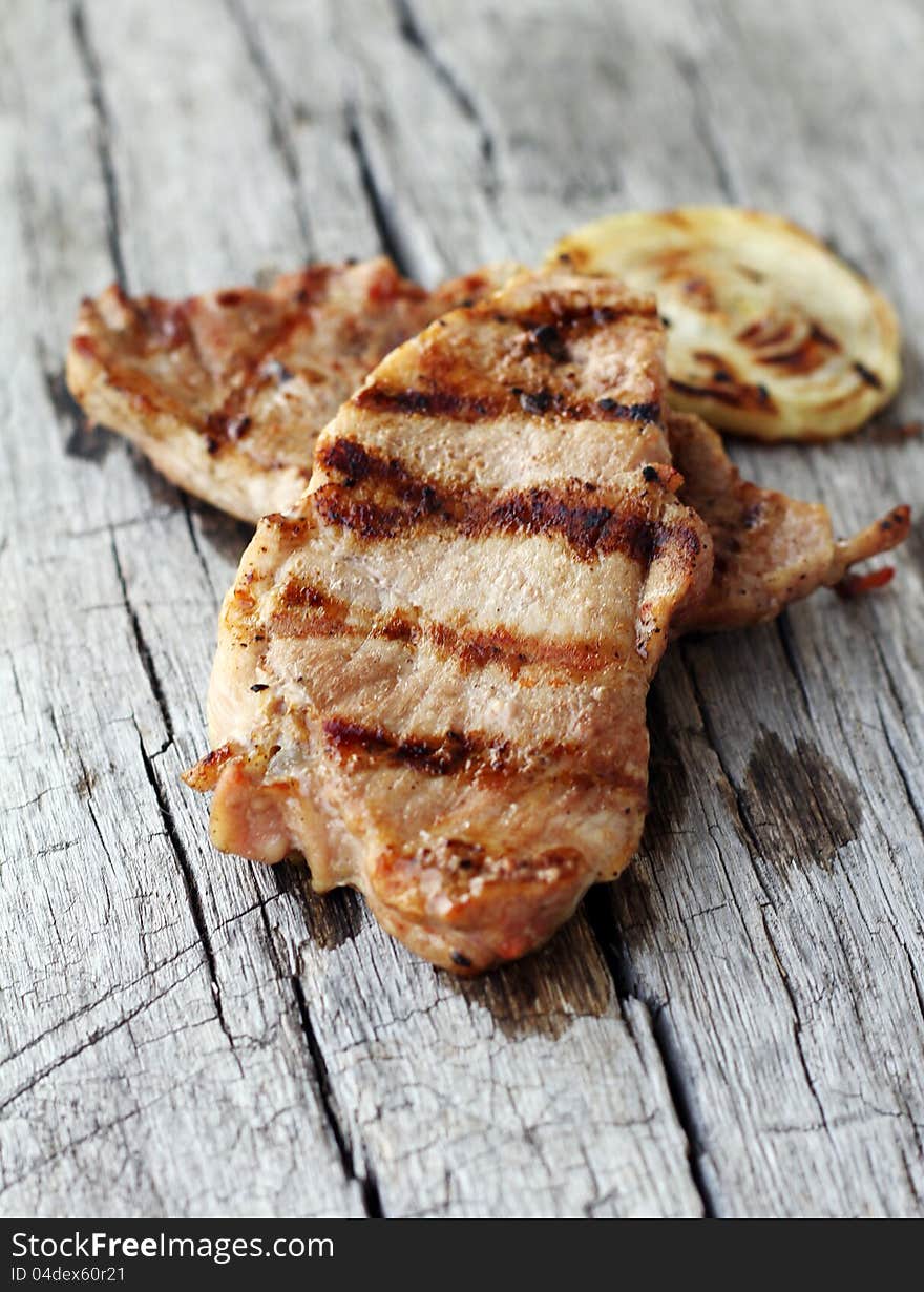 Grilled steak on wooden table