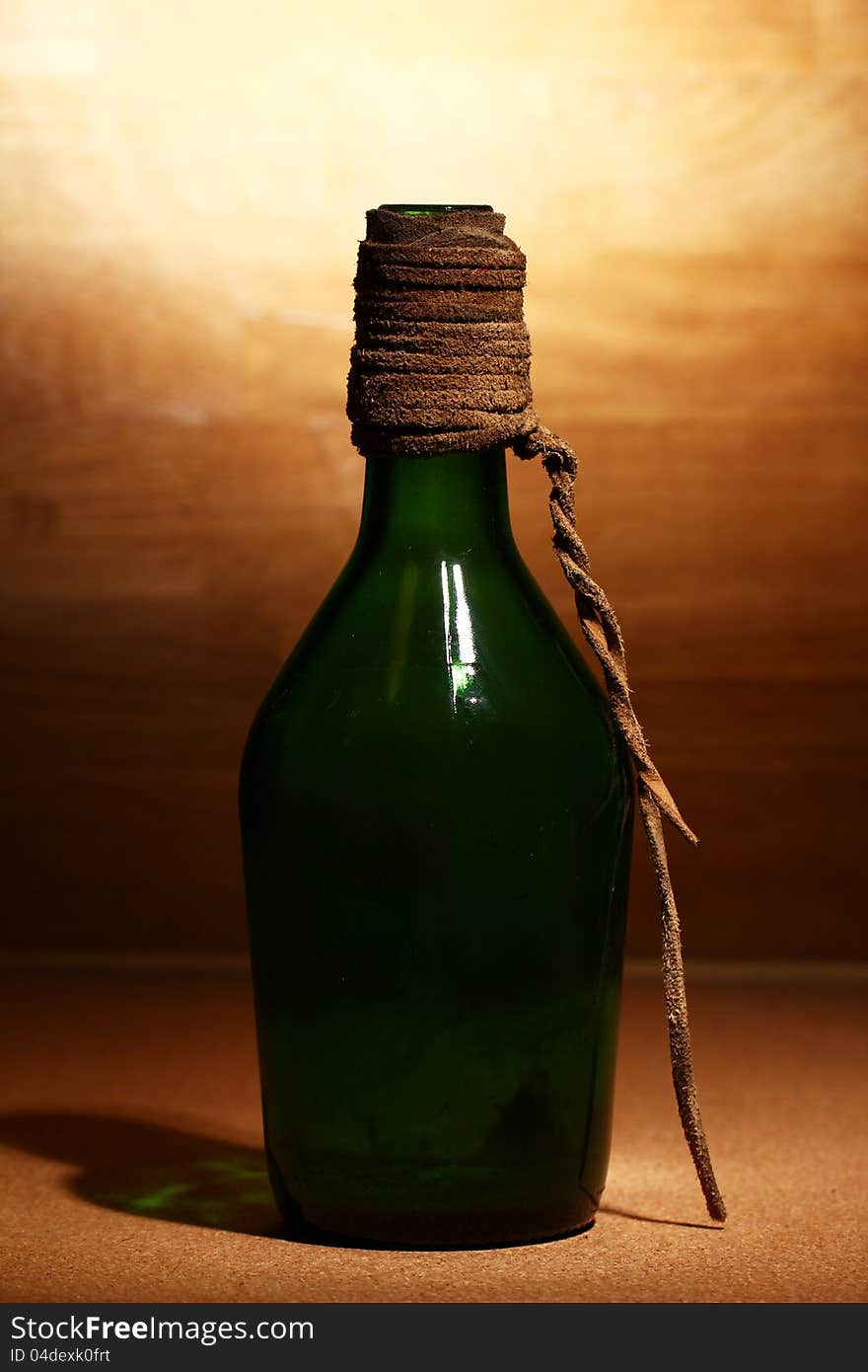 Old aged bottle over wooden surface