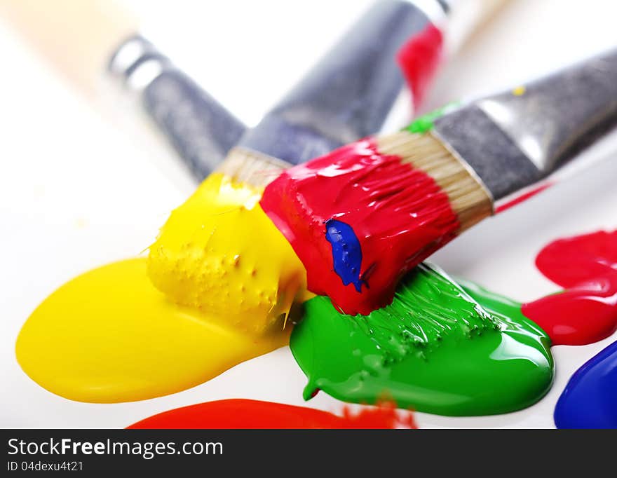 Close up of colorful paint and brushes