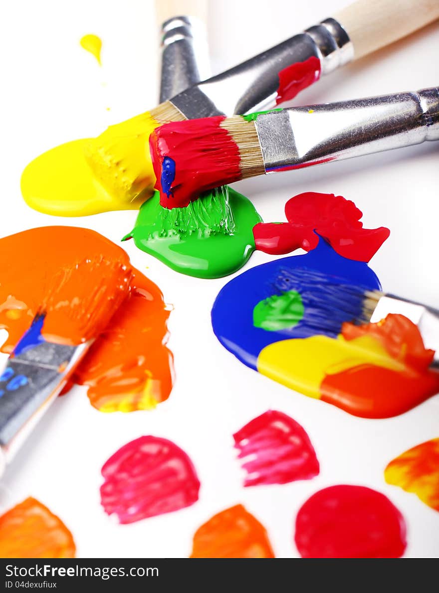 Close up of colorful paint and brushes