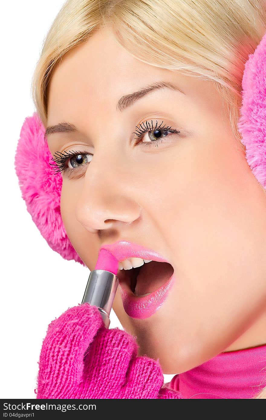 Woman in pink does make-up lipstick