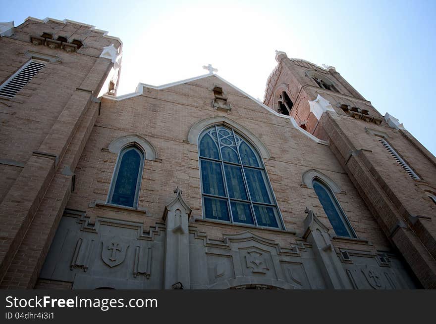 This is a church with neat architecture in front of the sun.  very illuminated