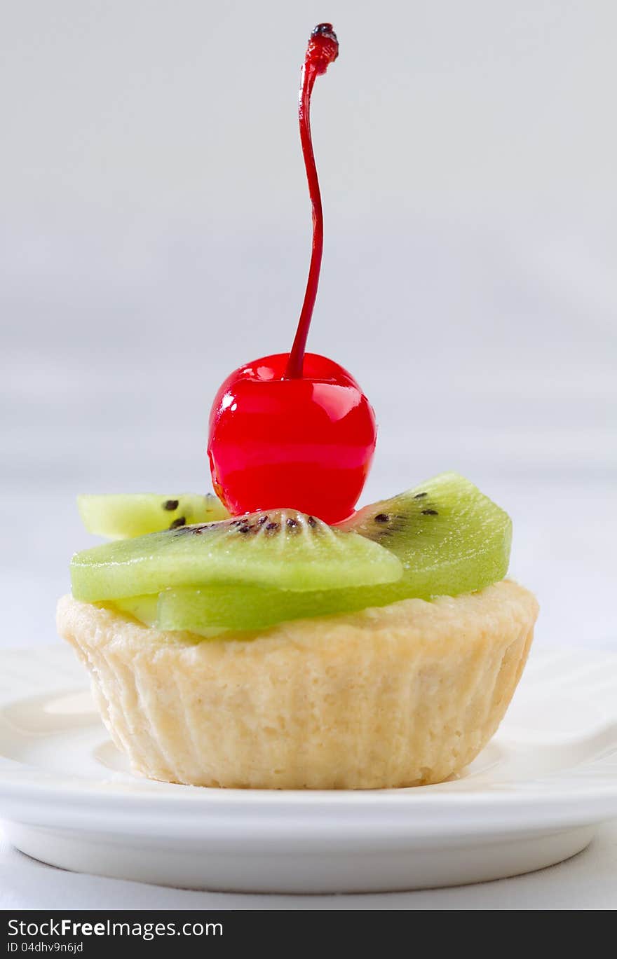 Sweet kiwi and cherry fruity tart confection snack ready made from restaurant