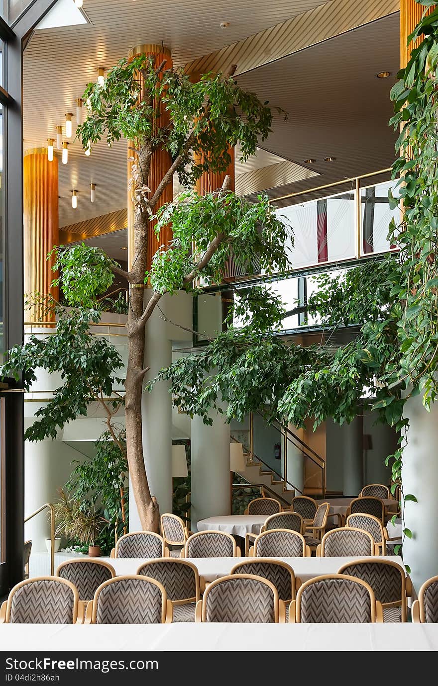 Foyer of a luxury hotel with pillars and greenery. Foyer of a luxury hotel with pillars and greenery