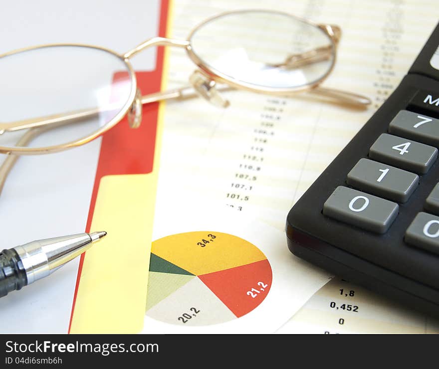 Chart with calculator, glass and pen. Chart with calculator, glass and pen