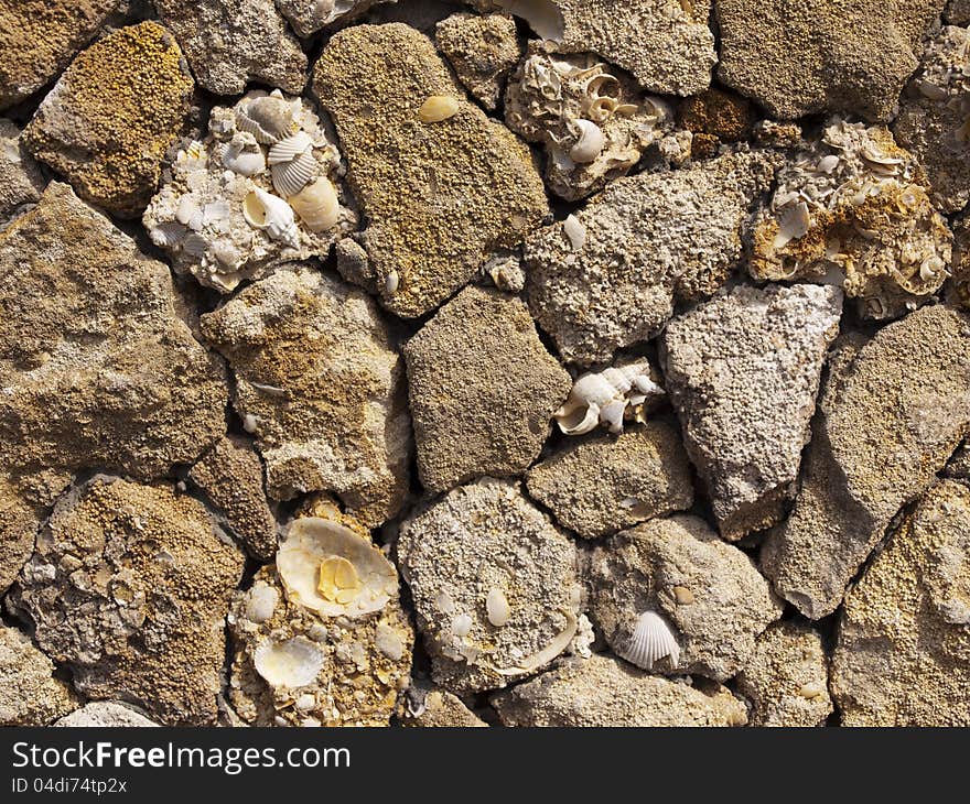 Fence of a natural building material of a yellow shell rock. Fence of a natural building material of a yellow shell rock