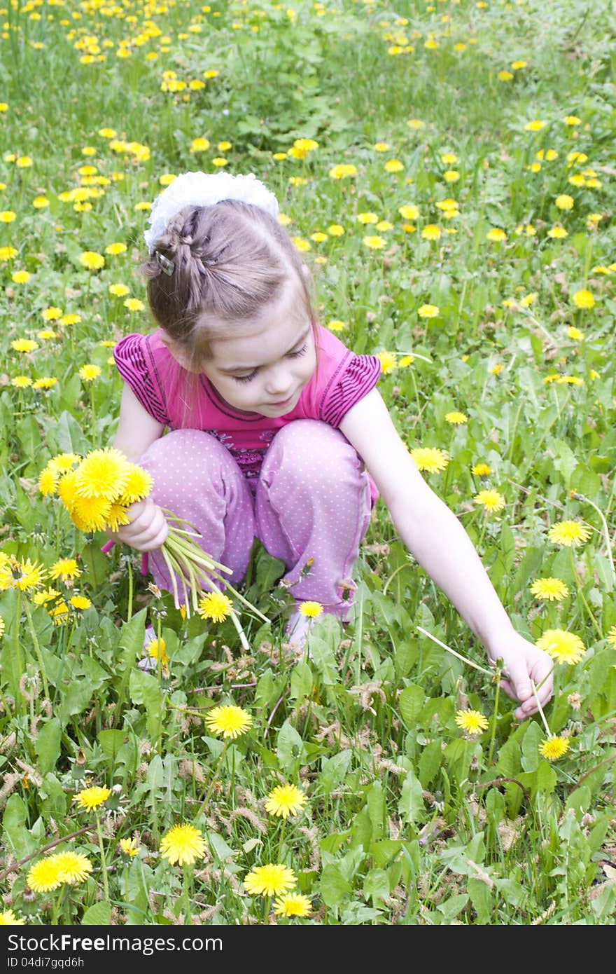 Young girl in a field of dandelions