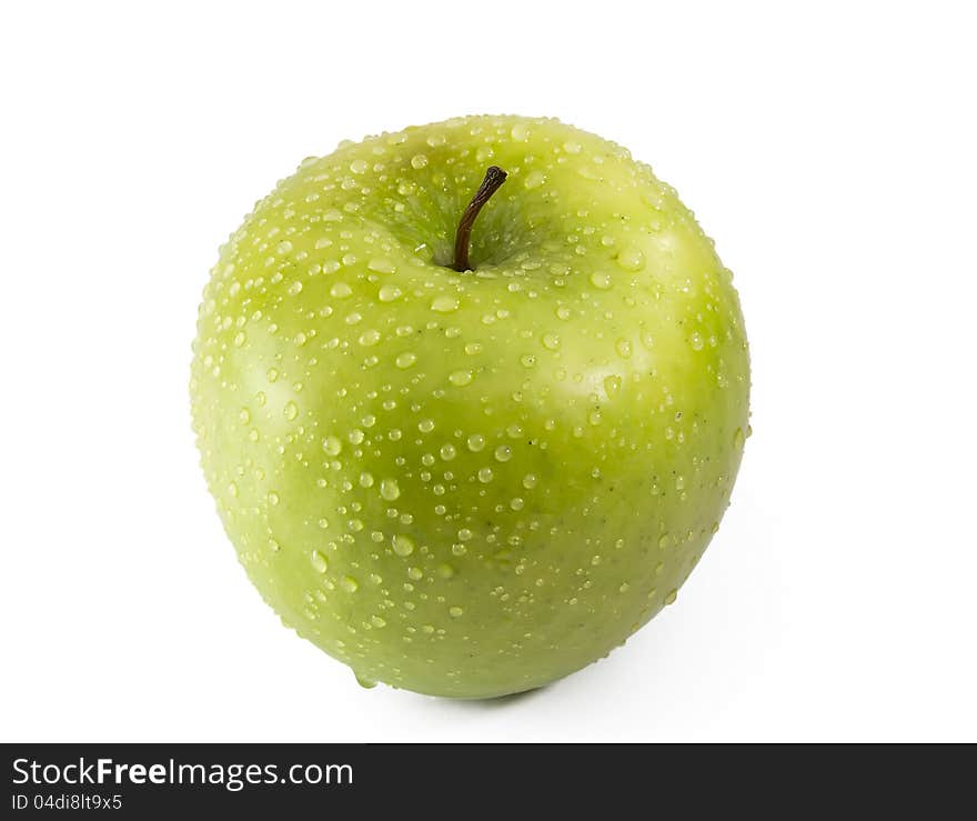 Green apple with drops of dew is isolated on a white background