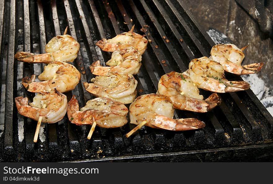 Cooking shrimp kebabs on the grill in the restaurant