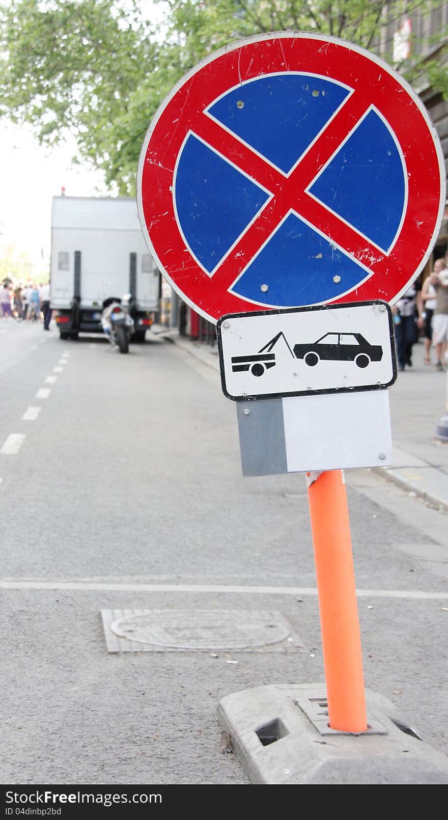 No stopping or standing traffic sign in the city, with blurred background.