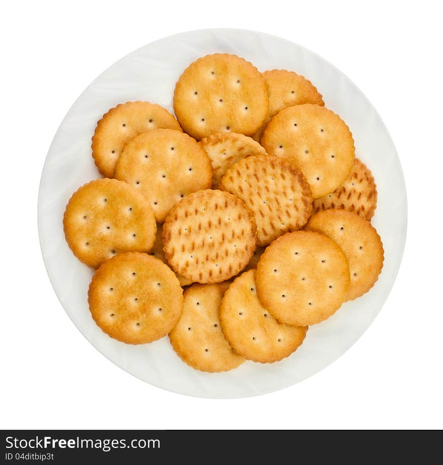 Heap of crackers on a plate against white background