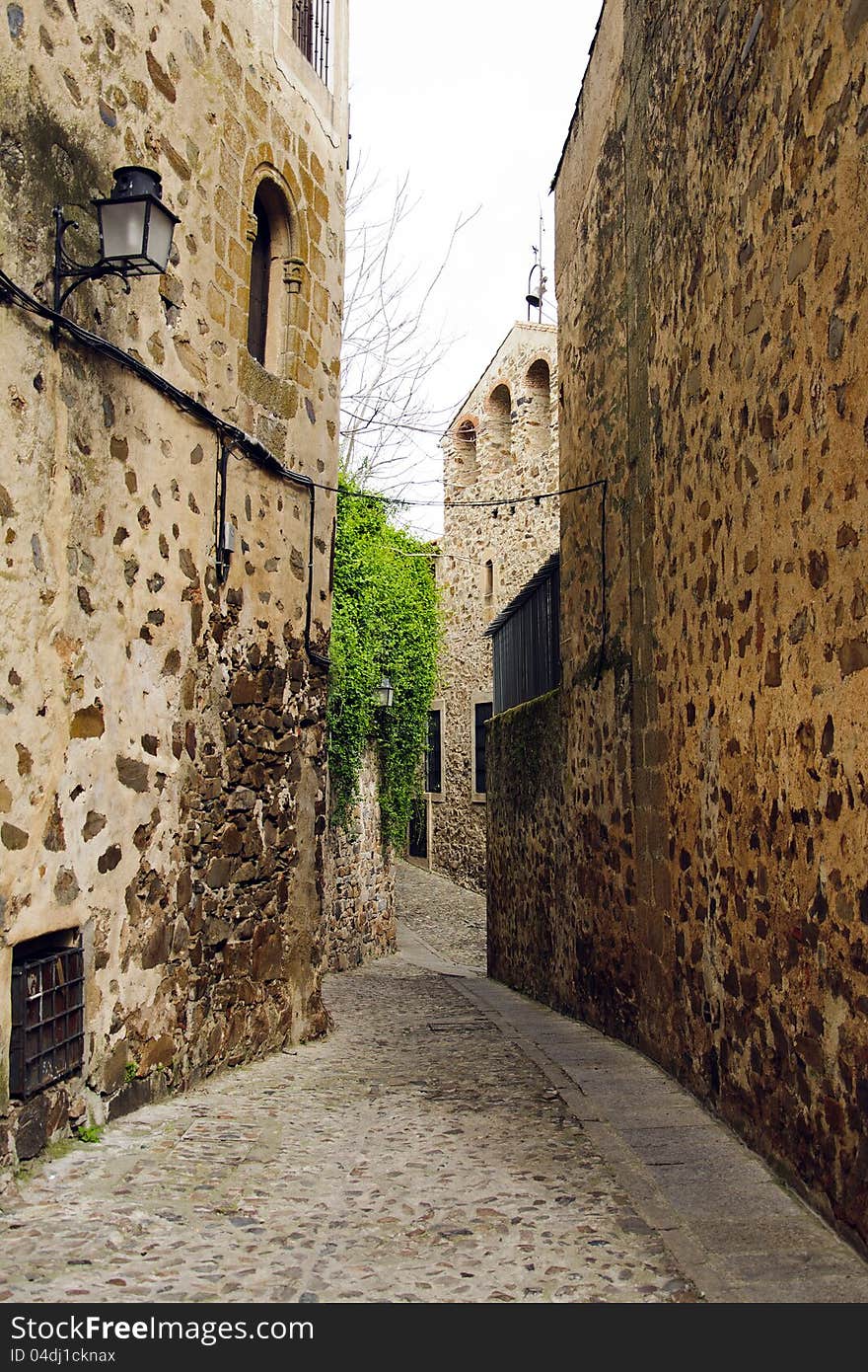 Narrow empty street in Caceres, Spain