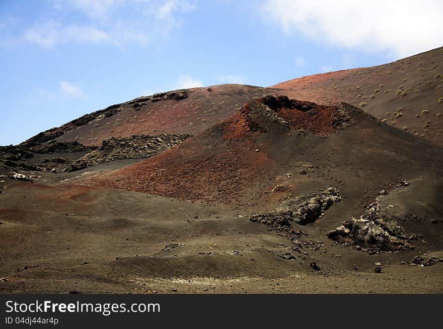 Volcanic landscape in Timanfaya National Park in Lanzarote (Canary Islands). The multiple volcanoes make the landscape look out of this world. Volcanic landscape in Timanfaya National Park in Lanzarote (Canary Islands). The multiple volcanoes make the landscape look out of this world.