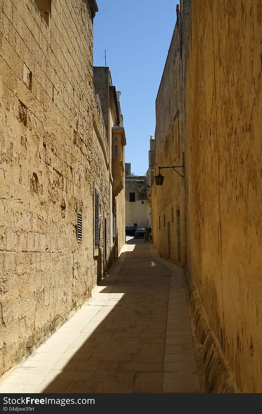 A narrow, winding side street in the Silent City of Mdina old capital of the island of Malta. A narrow, winding side street in the Silent City of Mdina old capital of the island of Malta