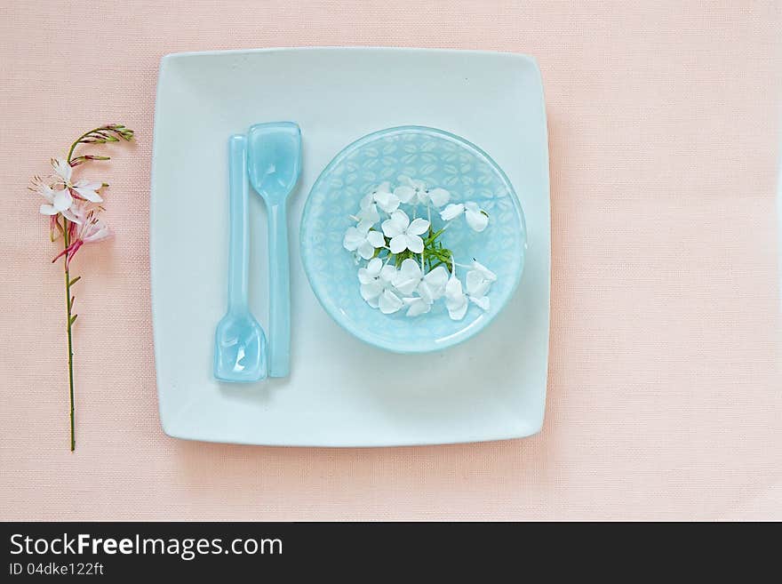 Table setting with glass bowl and flowers and space for text