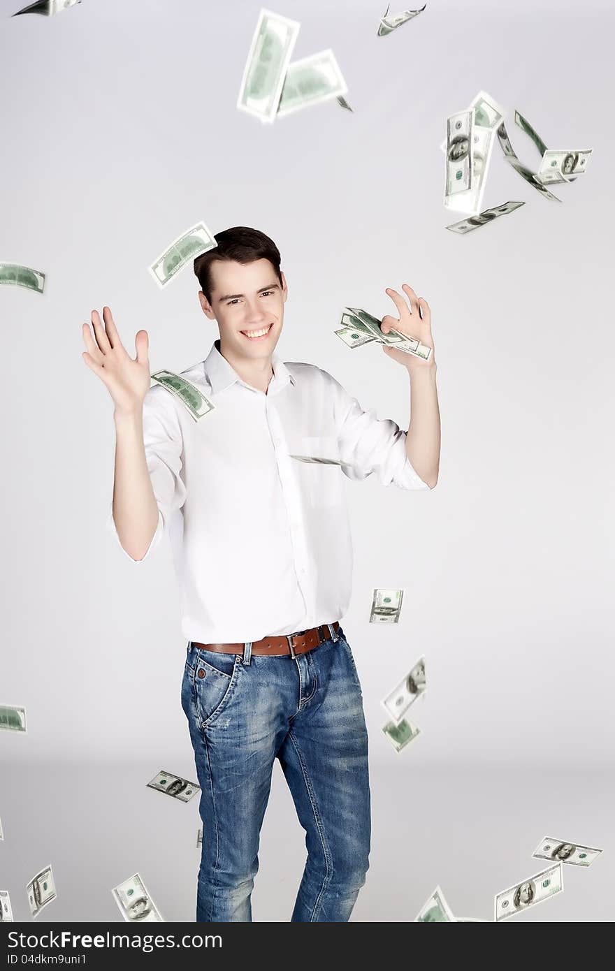 Young man celebrating a victory on light background