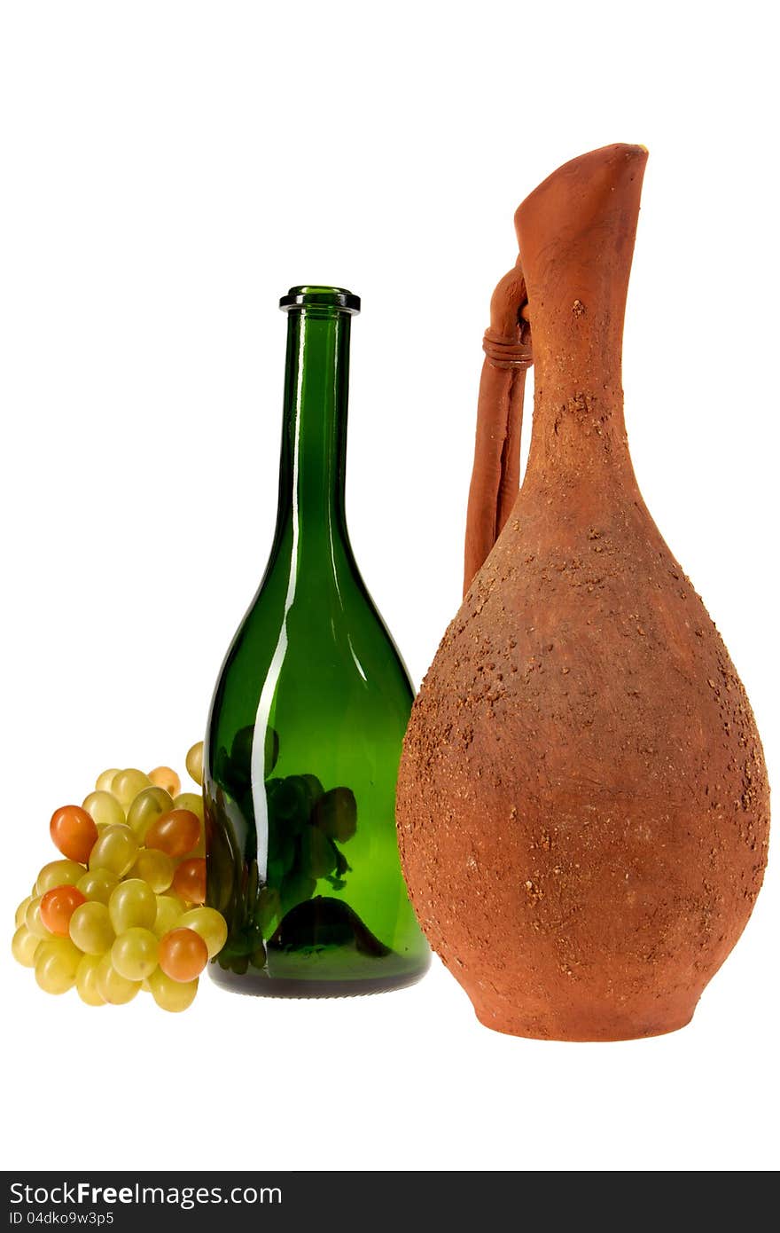 Pitcher, a glass bottle and a bunch of grapes on a white background. Pitcher, a glass bottle and a bunch of grapes on a white background