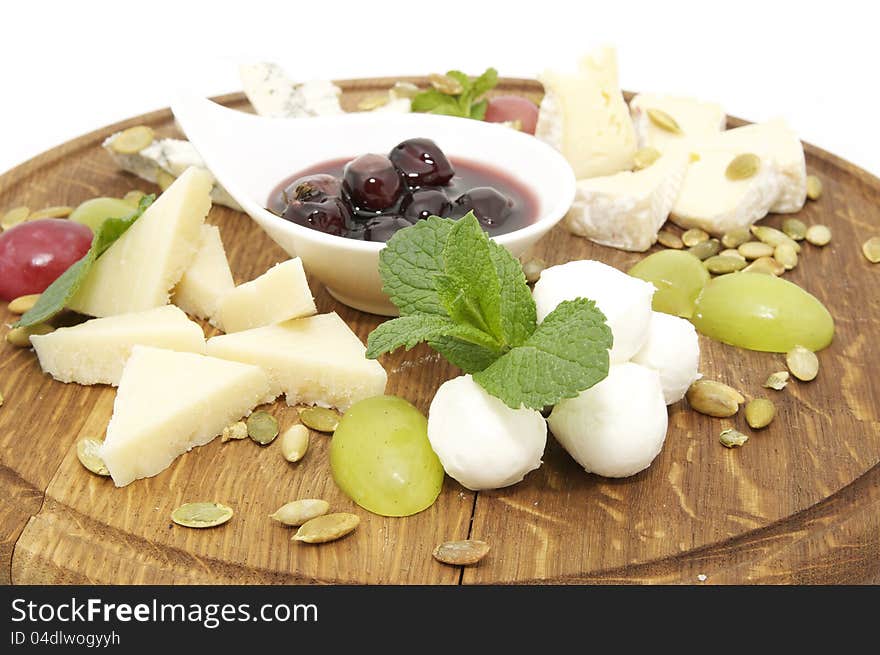 Cheese plate with several kinds of cheese on a white background