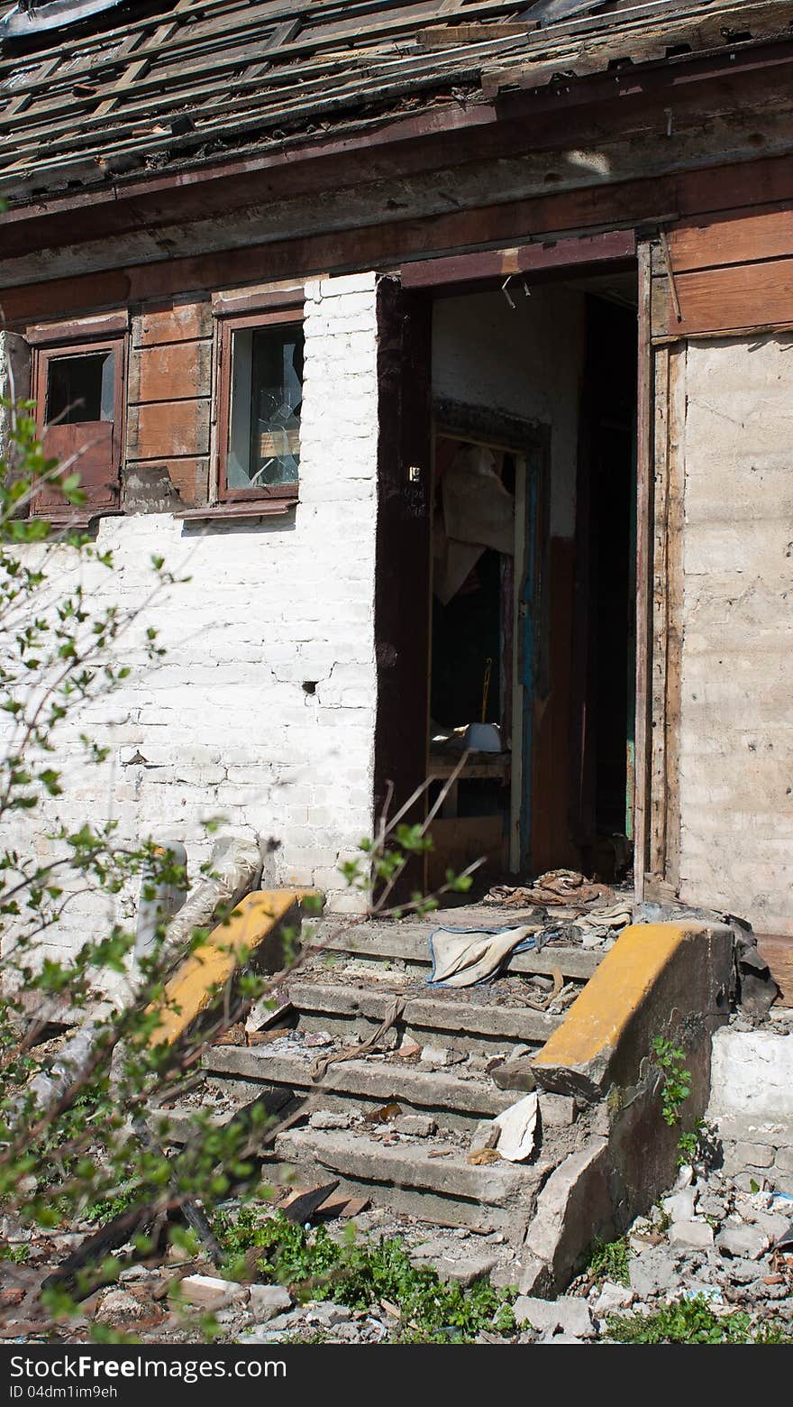 Door and room of abandoned broken house in sunny spring day