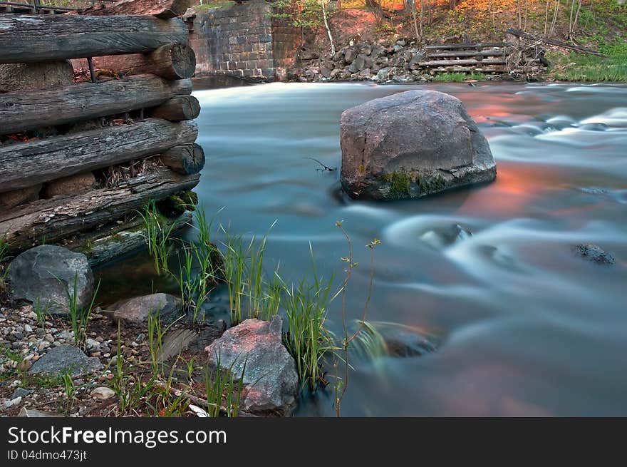 River landscape with stones and an old timbered felling